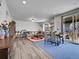 Open-concept living and dining area with sliding glass doors and stylish furnishings at 857 Gold Hill Dr, Erie, CO 80516