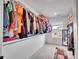 Well-organized walk-in closet with hanging clothes, shelving, and a window offering natural light at 857 Gold Hill Dr, Erie, CO 80516