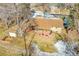 Aerial view of a fenced backyard with mature trees, a brick patio, and a grass area on a bright sunny day at 12286 W Tennessee Ave, Lakewood, CO 80228