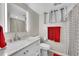Bathroom with a modern vanity, illuminated mirror, and stylish shower with patterned curtain at 12286 W Tennessee Ave, Lakewood, CO 80228