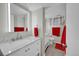 Modern bathroom with double sinks, white cabinets, and bright lighting at 12286 W Tennessee Ave, Lakewood, CO 80228