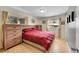 Cozy bedroom with hardwood floors, large windows, and a comfortable bed with a red comforter at 12286 W Tennessee Ave, Lakewood, CO 80228
