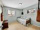 Cozy bedroom featuring light blue walls, hardwood floors, and a comfortable daybed at 12286 W Tennessee Ave, Lakewood, CO 80228