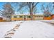 Inviting single-Gathering home with snowy front yard, charming curb appeal, and lush, mature trees at 12286 W Tennessee Ave, Lakewood, CO 80228