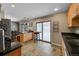 Well-designed kitchen featuring tile flooring, modern appliances, and a view into the dining area, great for cooking and entertaining at 12286 W Tennessee Ave, Lakewood, CO 80228
