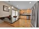 Modern kitchen with stainless steel appliances, granite counters, breakfast bar, and a sliding glass door at 12286 W Tennessee Ave, Lakewood, CO 80228