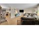 Spacious living room featuring a comfortable sectional sofa, hardwood floors, and natural light from the windows at 12286 W Tennessee Ave, Lakewood, CO 80228
