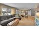 Comfortable living room with a large window, hardwood floors, and a plush sectional sofa at 12286 W Tennessee Ave, Lakewood, CO 80228
