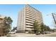 High-rise apartment building with multiple balconies and surrounding trees at 1029 E 8Th Ave # 901, Denver, CO 80218