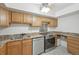 Functional kitchen with stainless steel appliances, granite counters, and wooden cabinets at 1029 E 8Th Ave # 901, Denver, CO 80218