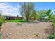 Gravel backyard with mature trees and a detached garage at 245 S 13Th Ave, Brighton, CO 80601