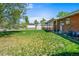 Green backyard featuring grass, mature tree, fencing, and storage shed at 245 S 13Th Ave, Brighton, CO 80601
