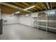 Unfinished basement storage area with shelving units and small windows at 245 S 13Th Ave, Brighton, CO 80601