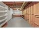 Unfinished basement with concrete floor, built-in shelving and workbench at 245 S 13Th Ave, Brighton, CO 80601