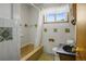 Functional bathroom with decorative tilework, and a shower with white shower curtains at 245 S 13Th Ave, Brighton, CO 80601
