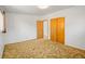 Simple bedroom with neutral walls, two closets, and carpeted flooring at 245 S 13Th Ave, Brighton, CO 80601