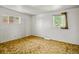 Cozy bedroom featuring two windows allowing for natural light, and plush carpeting at 245 S 13Th Ave, Brighton, CO 80601