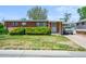 Charming single-story brick home with a covered parking area and well-maintained front yard at 245 S 13Th Ave, Brighton, CO 80601