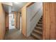Hallway with wood paneled walls and carpeted staircase at 245 S 13Th Ave, Brighton, CO 80601