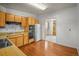 Functional kitchen features wood cabinets, tile backsplash, and hardwood flooring at 245 S 13Th Ave, Brighton, CO 80601