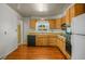 Well-lit kitchen with wooden cabinets, black dishwasher, and views to the backyard at 245 S 13Th Ave, Brighton, CO 80601