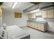 Bright basement laundry room with washer, dryer, and cabinets at 245 S 13Th Ave, Brighton, CO 80601