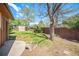 Spacious backyard with mature trees, lush lawn, privacy fence, and a storage shed at 12289 W Atlantic Ave, Lakewood, CO 80228