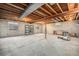 Unfinished basement featuring concrete flooring, exposed ceiling, and natural light from the windows at 12289 W Atlantic Ave, Lakewood, CO 80228