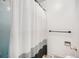 A simple bathroom features a bathtub with a shower curtain and white walls at 12289 W Atlantic Ave, Lakewood, CO 80228