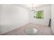 Bedroom featuring plush carpet flooring, a modern chandelier, and natural light from the large window at 12289 W Atlantic Ave, Lakewood, CO 80228