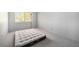 Empty bedroom with an air mattress, large window and neutral carpet at 12289 W Atlantic Ave, Lakewood, CO 80228