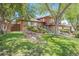 Charming two-story home with brick and siding, well-maintained landscaping, and mature shade trees at 12289 W Atlantic Ave, Lakewood, CO 80228
