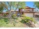 Charming two-story home with brick and siding, well-maintained landscaping, and mature shade trees at 12289 W Atlantic Ave, Lakewood, CO 80228