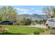 Street view showcasing a lush front lawn, mature trees, and beautiful landscaping near the home at 12289 W Atlantic Ave, Lakewood, CO 80228