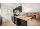 Efficient kitchen featuring black cabinets, wood countertops, and modern appliances for meal preparation at 12289 W Atlantic Ave, Lakewood, CO 80228