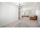 Bright living room showcasing carpet, view to other rooms, modern chandelier, and large window views at 12289 W Atlantic Ave, Lakewood, CO 80228