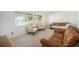 Bright living room featuring carpet flooring, two armchairs, and sofas near large windows at 12289 W Atlantic Ave, Lakewood, CO 80228