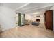 Cozy living area featuring wood floors, fireplace, neutral paint, and access to the backyard through glass doors at 12289 W Atlantic Ave, Lakewood, CO 80228