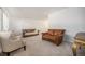 Bright living room features leather sofas, white chairs, and neutral carpeting at 12289 W Atlantic Ave, Lakewood, CO 80228