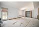 Unfinished living room with a window, closet, door, and fireplace at 12289 W Atlantic Ave, Lakewood, CO 80228