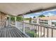 Balcony featuring a white railing with views of the complex, parking area, and mature trees at 18302 E Kepner Pl # 207, Aurora, CO 80017