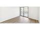 Bedroom with sliding glass doors providing ample natural light and neutral walls at 18302 E Kepner Pl # 207, Aurora, CO 80017