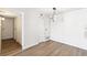 Bright dining area with a modern chandelier and wood flooring adjacent to kitchen and closets at 18302 E Kepner Pl # 207, Aurora, CO 80017