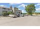 Apartment complex exterior with multiple parked cars on a sunny day at 18302 E Kepner Pl # 207, Aurora, CO 80017