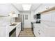 Updated kitchen featuring white cabinets, quartz countertops, stainless steel appliances, and wood floors at 18302 E Kepner Pl # 207, Aurora, CO 80017