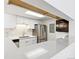 Galley kitchen with white cabinets, stainless steel appliances, quartz countertops, and tiled backsplash at 18302 E Kepner Pl # 207, Aurora, CO 80017