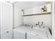 Convenient laundry room with washer, dryer, and storage shelf at 18302 E Kepner Pl # 207, Aurora, CO 80017