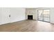 Bright living room featuring a stone fireplace, wood floors, and sliding glass doors to the balcony at 18302 E Kepner Pl # 207, Aurora, CO 80017