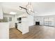 Inviting living room with a fireplace, adjacent to a modern kitchen with sleek, white cabinets at 18302 E Kepner Pl # 207, Aurora, CO 80017