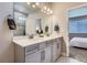 Bright bathroom with double sinks, gray cabinetry, and a glass-enclosed shower, all with modern fixtures at 13460 Broad Wing Ave, Parker, CO 80134